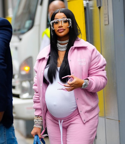 Cardi B pregnant wears pink sweatsuit with silver chains